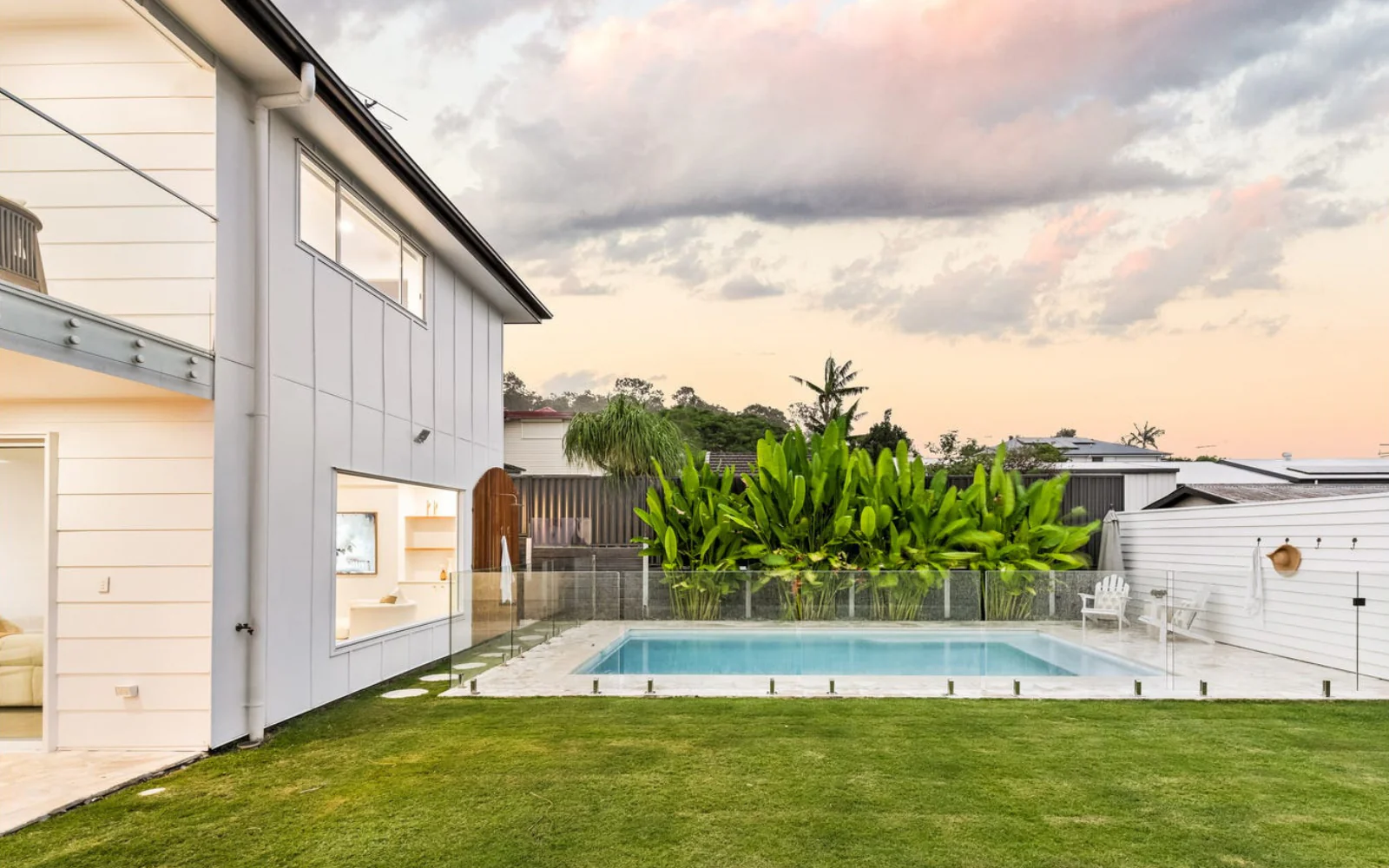 Custom LuxRo pool beside a modern Brisbane home at dusk